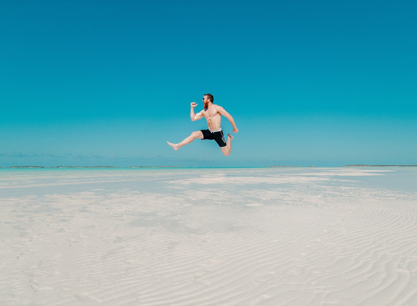 A child jumping on a shallow sandbar